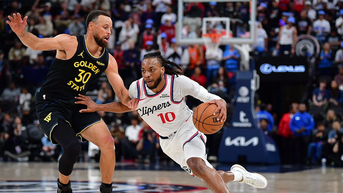 Stephen Curry defending Darius Garland during a basketball game